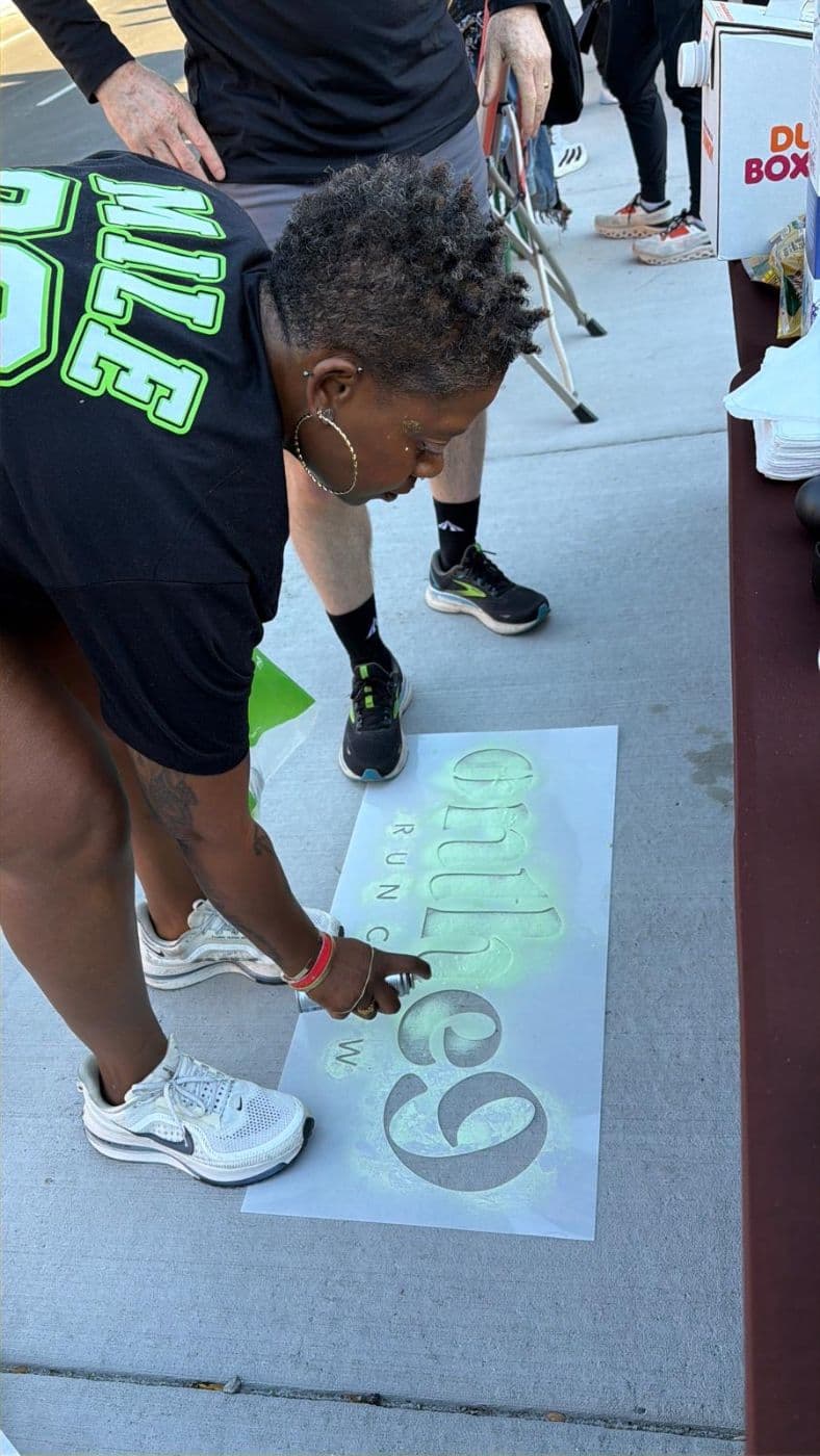 Spray-stenciling the OnThe9 logo